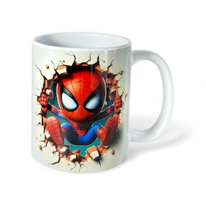 May include: White ceramic mug featuring a cartoon Spider-Man character breaking through a wall. The superhero is depicted in his classic red and blue suit, with a detailed mask. The mug has a curved handle and a glossy finish.