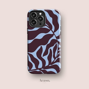 May include: A rectangular smartphone case featuring a dark brown and light blue abstract leaf pattern. The case has a cutout for a triple-lens camera system on the top left corner. The word Acaso. is printed in small black text below the phone case.
