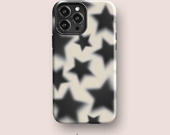 May include: A smartphone case featuring a cream-colored background with a repeating pattern of blurred, soft-edged black stars. The case includes a cutout for a triple-lens camera system on the upper left side. The word Acaso. is printed below.