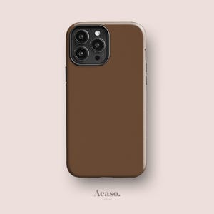 May include: A solid brown smartphone case with a smooth matte finish and a black camera module housing three circular lenses and a flash. The case features a rectangular shape with rounded corners and the text Acaso. London at the bottom.