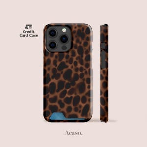May include: A brown and black leopard print phone case with a credit card slot at the bottom. The case features a triple camera cutout on the back and a side profile view showing the button placement. The text Credit Card Case is visible.