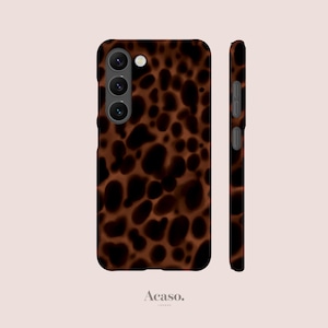 May include: A brown and black patterned phone case with a camera cutout. The case has a tortoiseshell design and is shown from the front and side. The brand name "Acaso" is printed at the bottom.