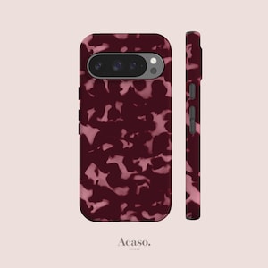 May include: A smartphone case featuring a dark burgundy and light pink mottled tortoiseshell pattern. The case includes a horizontal camera cutout at the top and side button covers. The text Acaso. LONDON is printed at the bottom center.