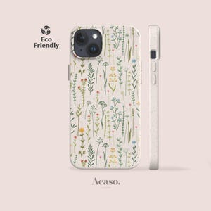 May include: A phone case with a speckled off-white base featuring a pattern of delicate wildflowers in shades of green, yellow, blue, and red. The case includes a black camera cutout and side buttons. Text on the image reads Eco Friendly and Acaso.
