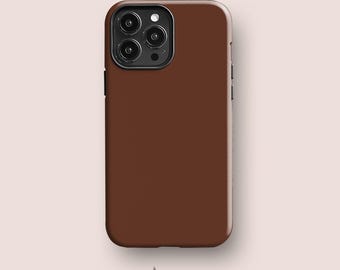 May include: A solid dark brown smartphone case with a smooth matte finish. The case features a rectangular camera cutout on the top left corner, housing three circular lenses and a flash. The brand name Acaso. London is printed below.