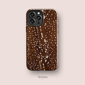 May include: A smartphone case featuring a dark brown background with a repeating pattern of irregular, light beige spots. The case has a cutout for a triple-lens camera system on the top left corner and the text Acaso. printed at the bottom.