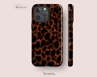 May include: A smartphone case featuring a brown and black leopard print pattern. The case includes a camera cutout, a MagSafe charging ring, and side button covers. The text Made for MagSafe and the brand name Acaso. London are visible.
