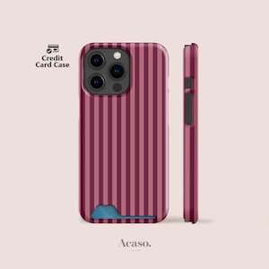 May include: A burgundy and dark pink striped phone case with a credit card slot at the bottom. The case features a triple camera cutout and a side profile view showing the button placement. The text Credit Card Case and Acaso are visible.