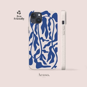 May include: A phone case with a cream-colored base and a bold, dark blue abstract leaf pattern. The case features a dual-camera cutout and a speckled, light-colored side profile with volume buttons. The text Eco Friendly and Acaso. are visible.
