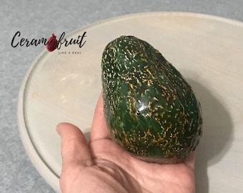 Avocado ceramic. Decorative product. Natural size. Glaze. Decoration of the festive table. Interior decoration.