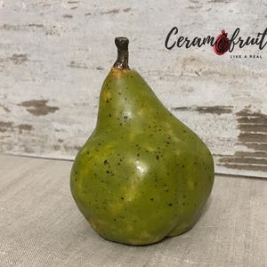 A pear. Ceramics. Glazed. Natural size. Pear figurine  for decorating the table setting.