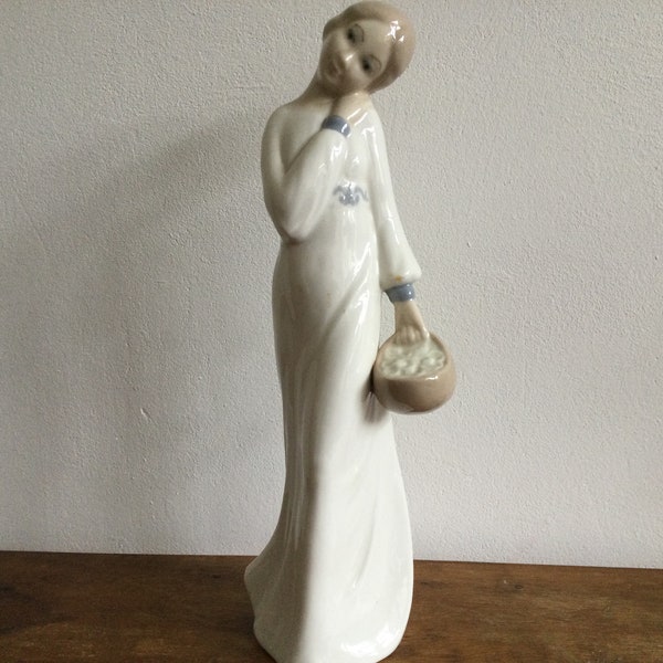 Rex Valencia figurine lady carrying Basket.