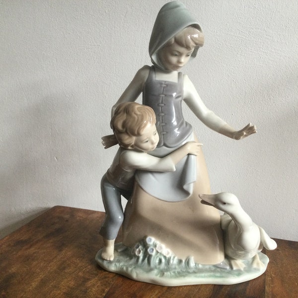 Lladro Figurine Boy and Girl avoiding Goose,Number 5033. Retired