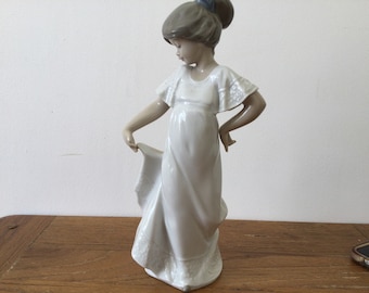 Lladro Nao ‘How Pretty,Girl holding up hem of gown.