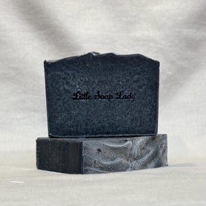 May include: Two bars of black charcoal soap with the text "Little Soap Lady" embossed on the top bar.