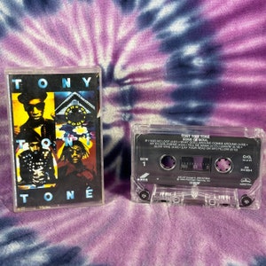 May include: A cassette tape of Tony Toni Tone's album "Sons of Soul". The cassette tape is clear plastic with a black label. The label has the album title, artist name, and track list. The cassette tape is on a purple and blue tie-dye background.