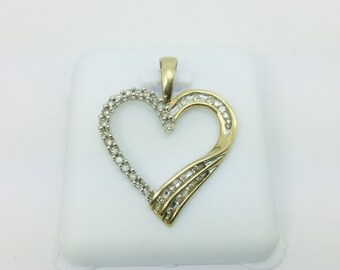 May include: A gold heart-shaped pendant with a diamond-encrusted design. The pendant features a twisted heart shape with diamonds set along the edges and in the center.