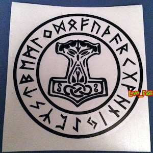 May include: Black and white image of a stylized hammer with a circle of runes around it. The runes are in a circular pattern and are all in the same size and style. The hammer is in the center of the circle and is facing upwards. The hammer has a long handle and a large head with a knot at the top.