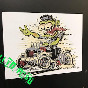 May include: A cartoon illustration of a green monster with its tongue sticking out driving a black hot rod with the word "DUNKIE" on the monster's hat.