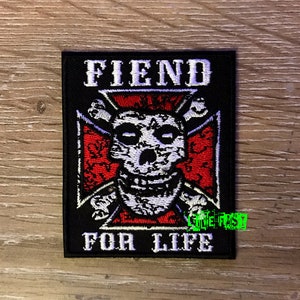 May include: Black embroidered patch with a white skull and crossbones design. The text "FIEND FOR LIFE" is written in white on a black background.