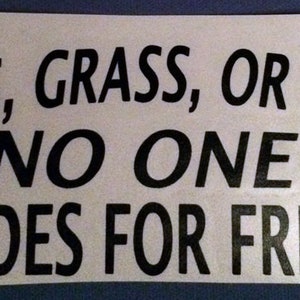 May include: Black and white sticker with the text "GAS, GRASS, OR ASS NO ONE RIDES FOR FREE!" and the text "Live_Fast" in smaller letters in the top right corner.