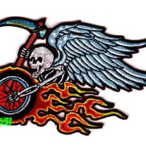 May include: An embroidered patch featuring a skeleton riding a motorcycle with flames and wings. The skeleton is holding a scythe and the motorcycle has a single wheel.