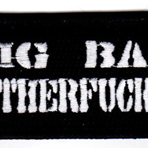 Può includere: Toppa ricamata nera con testo bianco che recita "Big Bad Motherfucker".