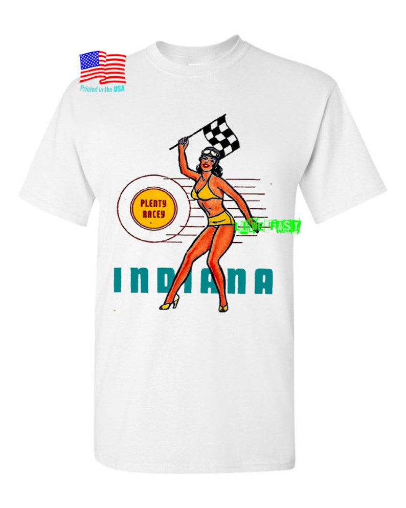 May include: White t-shirt with a graphic of a woman in a swimsuit holding a checkered flag. The graphic also includes the text "Plenty Racey" and "Indiana".