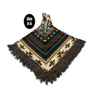 May include: A brown, blue and white patterned poncho with a fringe border. The poncho has a hood and says "Size 5-6" on a black tag.