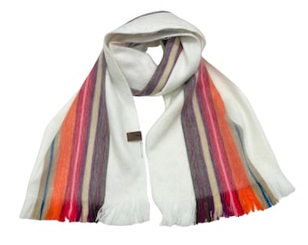 May include: White scarf with colorful stripes. The scarf has a fringe on the ends.