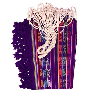 May include: A folded purple hammock featuring vertical stripes in yellow, orange, blue, and pink. The fabric displays repeating geometric patterns and stylised fish motifs. Thick, off-white braided cotton ropes are attached to the top edge.