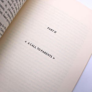 May include: A book page with the heading "PART II" and the title "A CALL TO PARENTS" in black. The paper is a cream colour, with the text positioned to the right. The left edge of the book is visible.