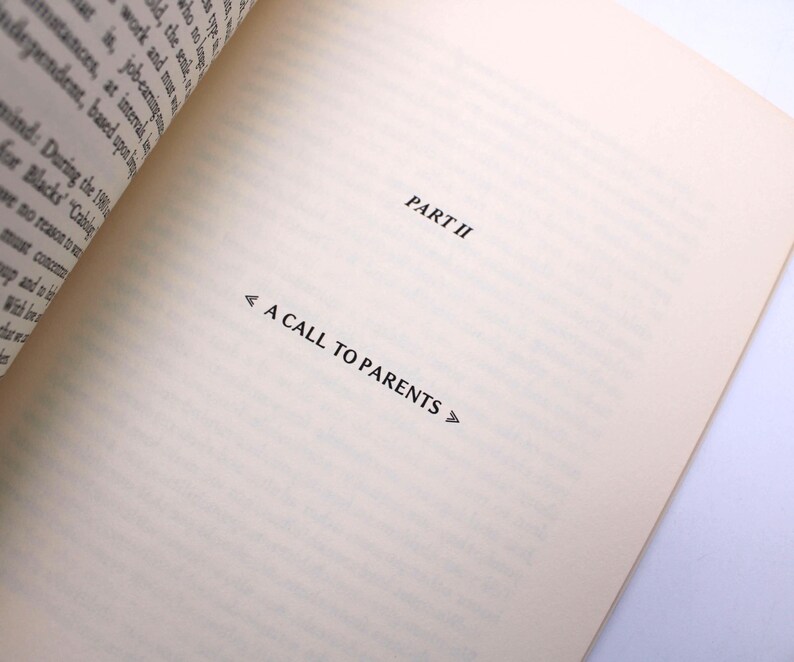 May include: A book page with the heading "PART II" and the title "A CALL TO PARENTS" in black. The paper is a cream colour, with the text positioned to the right. The left edge of the book is visible.