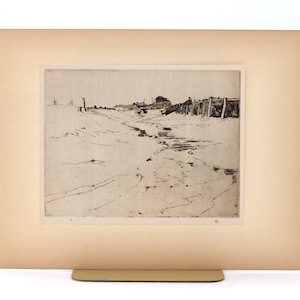 May include: A black and white etching of a landscape scene, featuring a path leading towards a distant structure. A wooden fence and several posts are visible. The artwork is mounted on a cream-colored mat.