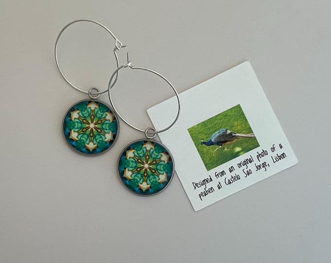 Make a statement with these stunning hoop earrings with a vivid original design on glass set on steel bezel with sterling hoop