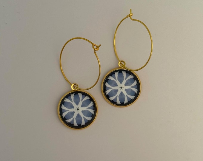 Make a statement with these stunning hoop earrings with a vivid original design on glass set on steel bezel with sterling hoop