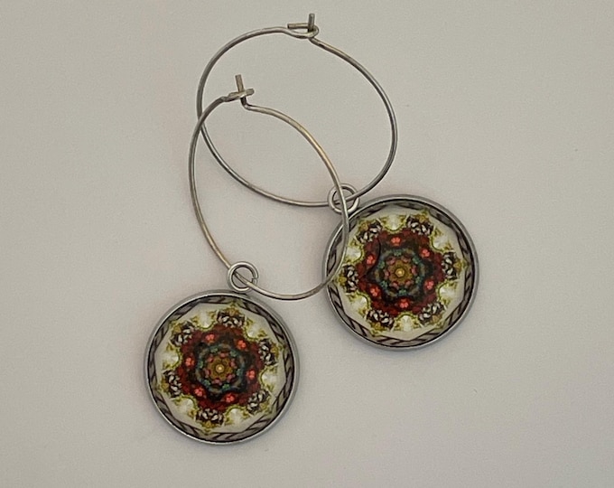 Make a statement with these stunning hoop earrings with a vivid original design on glass set on steel bezel with sterling hoop