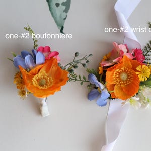 May include: A boutonniere and a wrist corsage labeled one-#2, featuring artificial orange poppies, blue flowers, small yellow blossoms, and green foliage. The wrist corsage includes a white satin ribbon for attachment to the wrist.