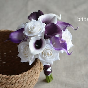 May include: A bridal bouquet with white roses and purple calla lilies. #2 bridesmaid