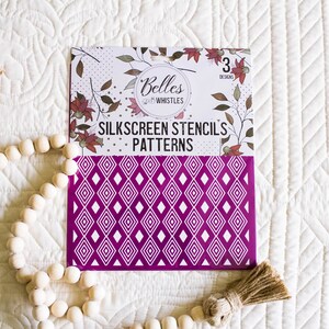 May include: A pack of three silkscreen stencil patterns featuring a geometric diamond design. The stencils are purple with white diamond shapes. The packaging features the text "Belles & Whistles" and "Silkscreen Stencils Patterns".