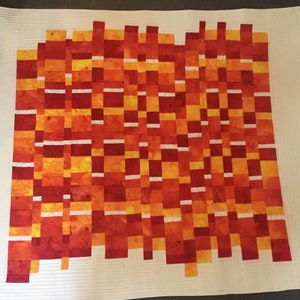 A striking wall hanging or lap quilt. &quot;In the Dash&quot; is vibrant reds, oranges and yellows with white &quot;dashes&quot; through out.