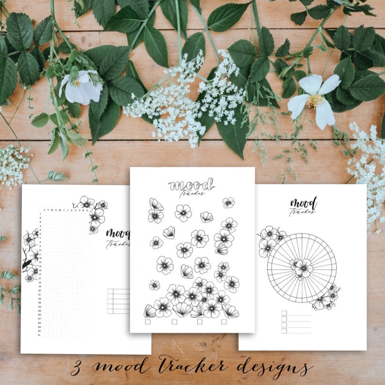 May include: Three printable mood tracker designs featuring floral illustrations. Each design includes the text "mood tracker".
