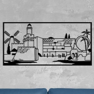 May include: Black and white silhouette of a city skyline with a windmill, a tower, and a wall. The image is framed and displayed on a gray wall.