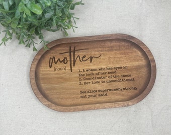May include: Wooden tray with a definition of "mother" engraved on it. The definition reads: "A woman who has eyes in the back of her head. Coordinator of the chaos. Her love is unconditional. See also: superwoman, strong, not your maid."