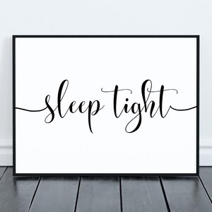 May include: Black and white printable wall art with the text "sleep tight" in a cursive font.