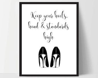 May include: Black and white printable wall art with the text "Keep your heels, head & standards high" and a pair of black high heels.