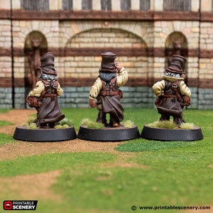 May include: Three miniature figures of people wearing brown coats and hats, standing on black bases. The figures are painted in brown, beige, and white.
