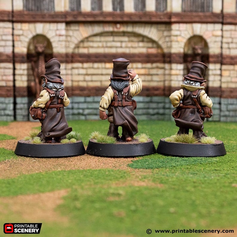 May include: Three miniature figures of people wearing brown coats and hats, standing on black bases. The figures are painted in brown, beige, and white.