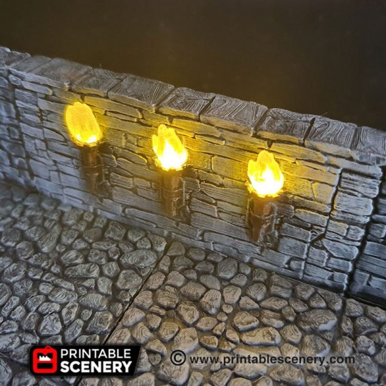 May include: Three lit torches mounted on a stone wall. The torches are made of a dark brown material and have a yellow flame. The wall is made of gray stone with a rough texture.