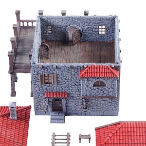 May include: A grey stone building with a red tiled roof and a wooden balcony. The building is made of several pieces that can be assembled to create a miniature model.